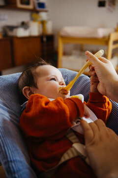 Baby being fed with spoon