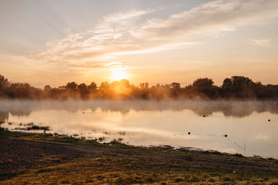 Sunrise over misty river landscape on a summer morning
