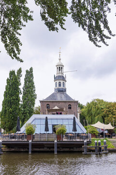 Historic Zijlpoort tower gate and modern pedestrian bridge over canal in Leiden, Netherlands