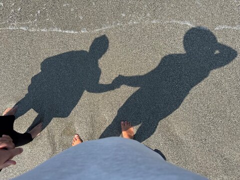 Shadow of Couple Holding Hands on Sand