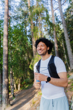 Smiling Athlete Holding Blue Flask