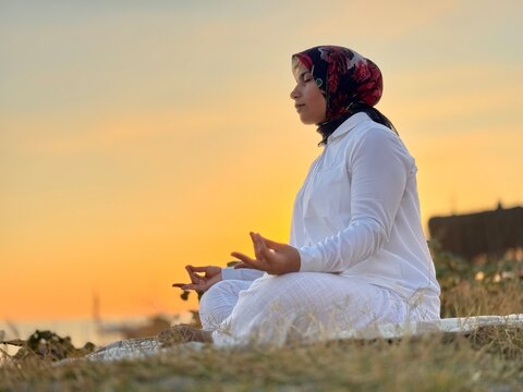 Meditating in White at Sunset