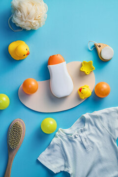 Baby bath time essentials arranged on a blue surface