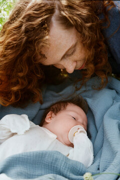 Mother cares for baby in a garden setting