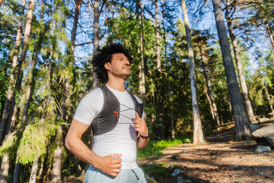 Runner Holding Vest Straps Outdoors