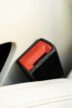 Red seat belt buckle detail inside an electric car