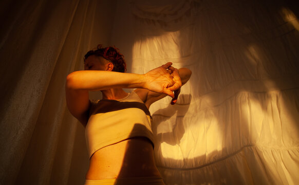 Stretching and home mindfulness in the warm sunlight