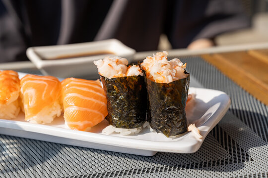 Salmon nigiri sushi with seaweed on ceramic plate