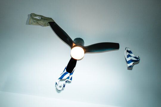 swimwear flying off a spinning ceiling fan indoors