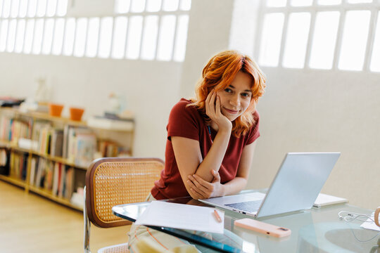 Woman smiling while working at home