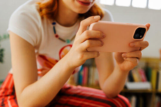 Woman holding a mobile phone enjoying digital content