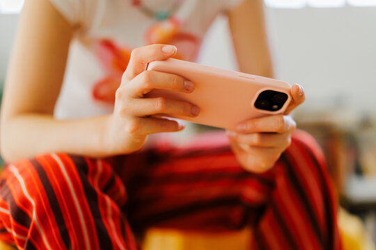 Woman holding smartphone using mobile technology device
