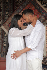 Romantic Indian couple sharing an intimate moment while embracing in a beautifully decorated...