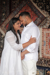 Romantic Indian couple sharing an intimate moment while embracing in a beautifully decorated...