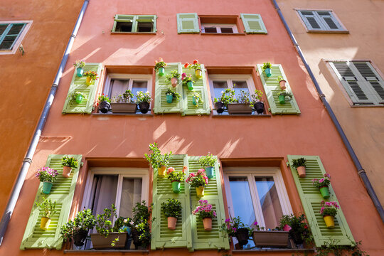 Pastel facade with flowered shutters in Nice, France