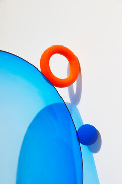 Minimal abstract composition with blue sphere and orange ring