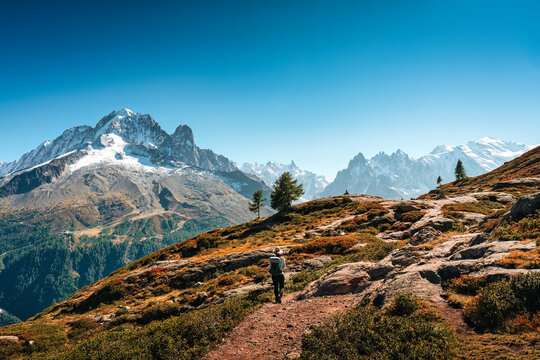 Solo Female Hiker Standing on Mountain Ridge Looking at Mont Blanc Massif in Chamonix French Alps