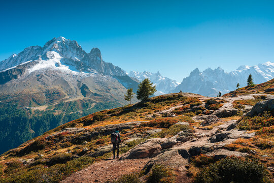 Solo Hiker Standing on Mountain Ridge Looking at Mont Blanc Massif in Chamonix French Alps