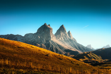 Obraz premium Famous Rocky Three Peaks with Golden Hill and Blue Sky in French Alps France