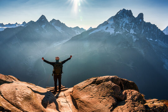 Successful Solo Hiker on Mountain Ridge and Mont Blanc Massif on Sunny Day at Chamonix France