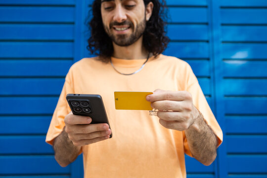 Man use smartphone and credit card for online payment