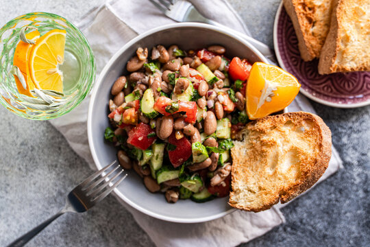 Bean and vegetable salad with cucumber tomato and bread