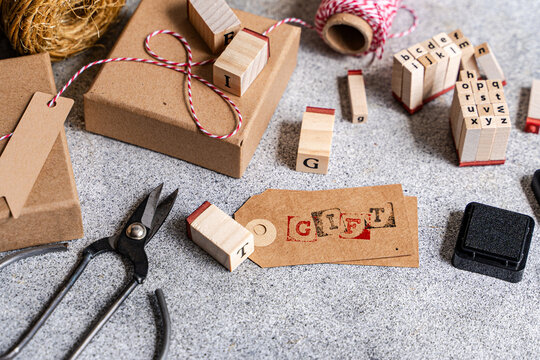 Handmade gift wrapping with stamps, tag and twine
