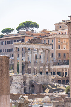 Ancient Roman temple ruins amid historic architecture in Rome