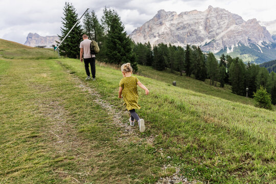 Father and daughter hike near Piz la Ila in the Dolomites