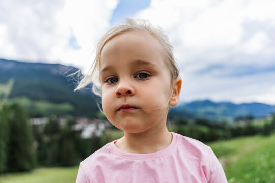 Child portrait in Dolomites meadow near La Villa, Italy
