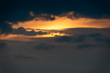 Obraz premium A breathtaking view of a dramatic sunset with dark clouds and glowing golden light piercing through the sky over Datian Mountain in Xizhi, New Taipei City, Taiwan.