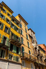 Fototapeta premium Historic Yellow Facades with Green Wooden Shutters in Piazza delle Erbe in Verona City Center Italy