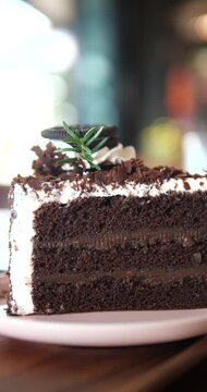 Close up of sliced chocolate fudge cake with oreo cookie and chocolate flakes