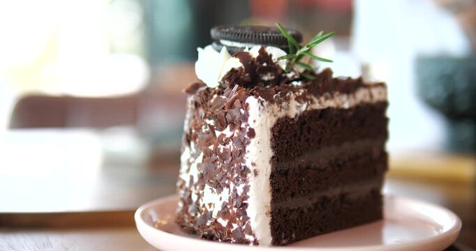 Close up of sliced chocolate fudge cake with oreo cookie and chocolate flakes