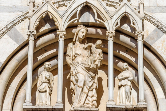 PISA, ITALY - JUNE 22, 2026: The marble statue of Madonna on the facade of church Chiesa di San Michaele in Borgo by Lupo di Francesco from first part of 14. cent. 