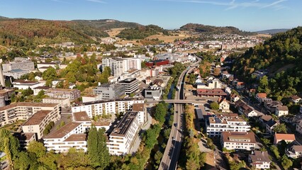 Fototapeta premium Aerial view of a Swiss town with railway corridor and residential buildings in Basel-Landschaft