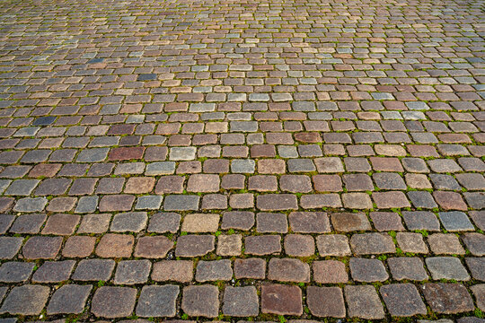 Cobblestone texture marks a paved pathway. Cobblestone texture features weathered stone blocks. Historic road uses cobblestone texture. Urban surface highlights cobblestone texture.