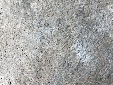 Rough Gray Concrete Surface with Small Pebbles and Uneven Texture