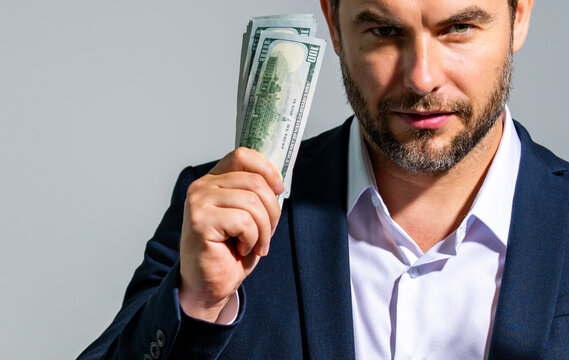 Make money concept. Businessman with dollars, success and wealth. Cash money and savings money. Rich man cash payment US dollars banknotes for mortgage credit. Business success and financial planning.