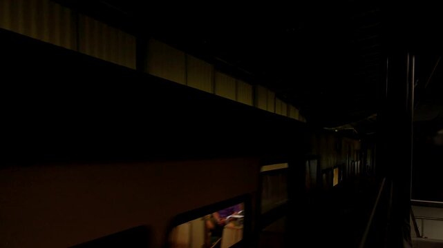 Old-fashioned funicular train traveling on a mountain railway through a dark tunnel. Switzerland