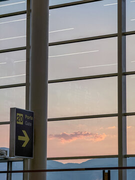 Airport terminal window overlooking colorful sunset sky view