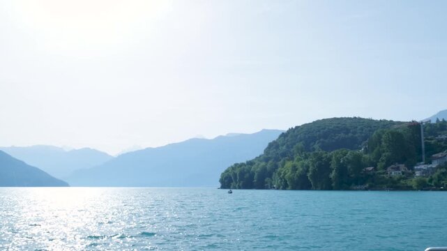 Beautiful turquoise water of lake thun with the alps mountains in the background. Switzerland