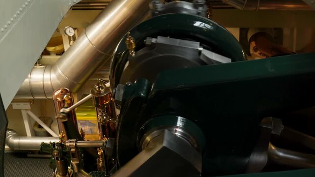 Close-up of a powerful vintage steam engine with its pistons and crankshaft rotating. Switzerland