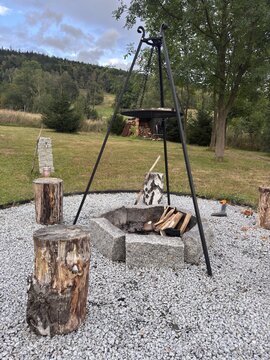 Tripod grill over stone fire pit