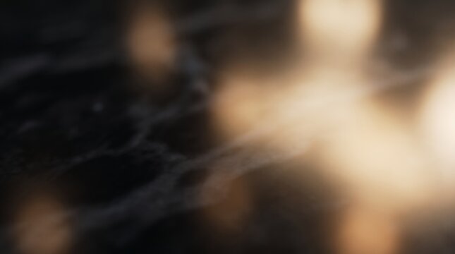 Abstract background with soft golden light leaks and blurred dark textures for creative design projects