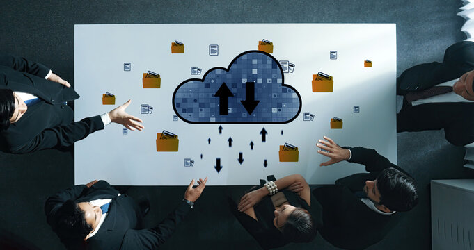A business team collaborates on cloud computing solutions, exploring data transfer and file management strategies during a strategic meeting. Trope