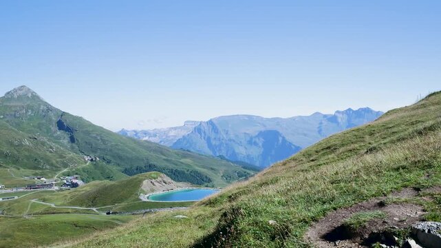 Panning video of the stunning alpine landscape of grindelwald first with a lake in switzerland. Switzerland
