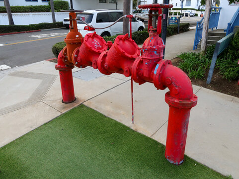 Red Commercial Fire Sprinkler Backflow Preventer Valve Assembly on Sidewalk