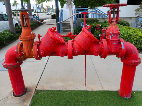 Red Commercial Fire Sprinkler Backflow Preventer Valve Assembly on Sidewalk