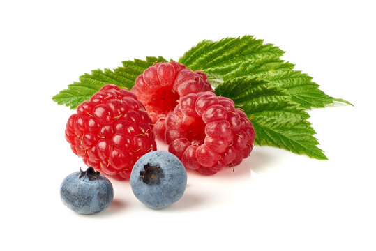 Ripe raspberries and blueberries with green leaf on white background arranged close up, with raspberry, blueberry, leaf, berry detail, showing fruit, fresh, ripe, closeup context